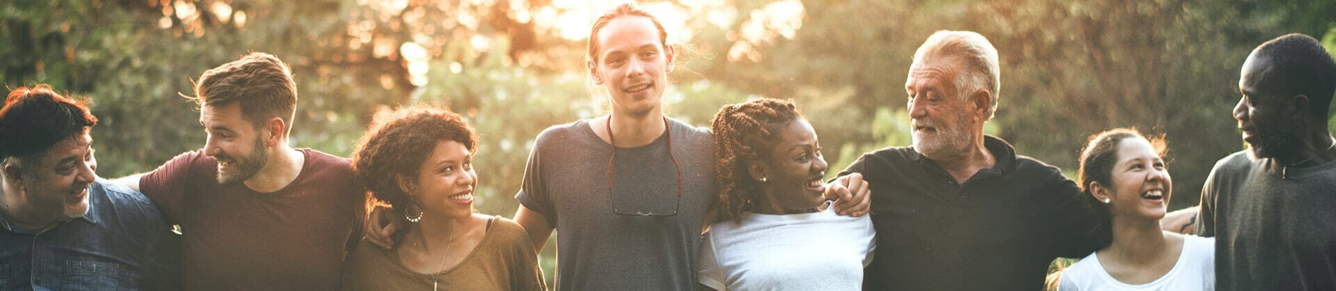Image of a group of people walking together with arms around each other